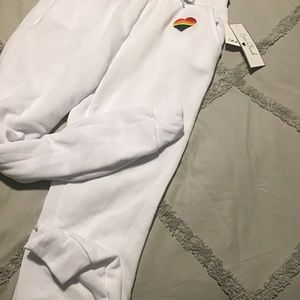 White joggers with a rainbow heart on the left hip
